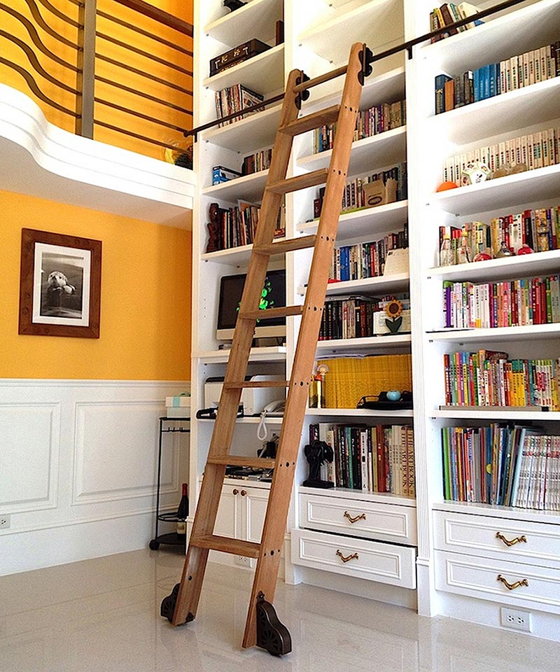 A grand, custom-built library with a rolling ladder